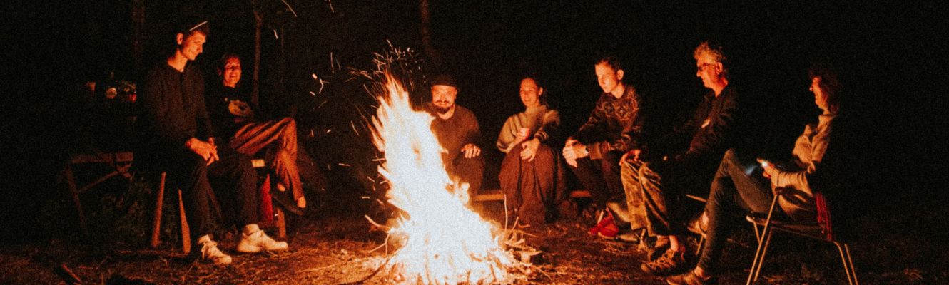 people gathering around bonfire